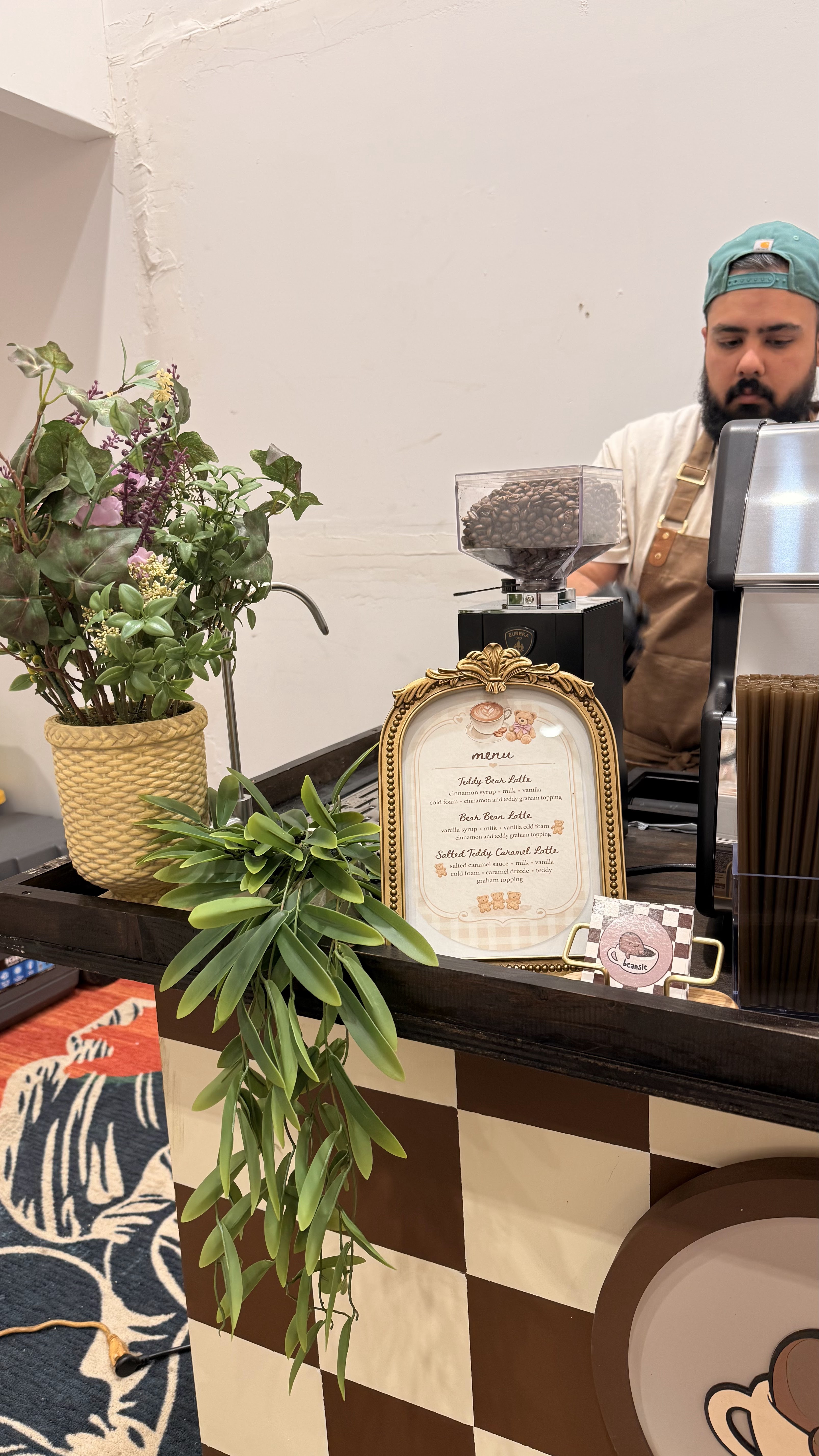 Beansie barista preparing an order behind the cart